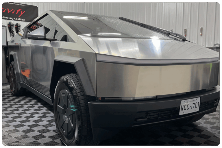 A Tesla truck with fresh window tint shines inside a Huntingdon & Blair PA shop