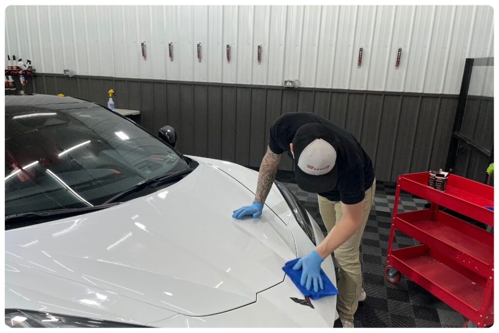 A professional ceramic coating specialist in Blair County PA polishes a luxury vehicle.