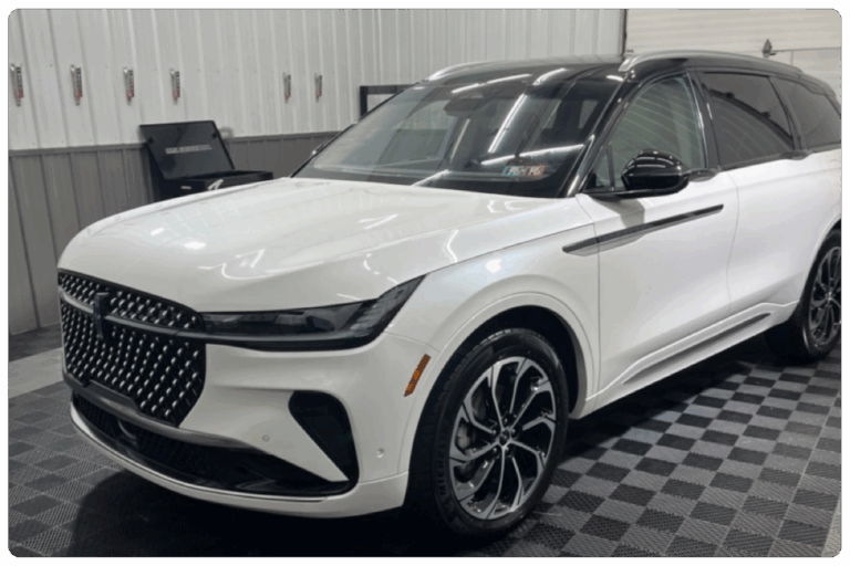 A polished detailed car sits in a Blair County detailing shop.