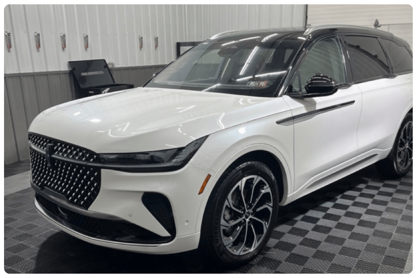 A polished detailed car sits in a Blair County detailing shop.